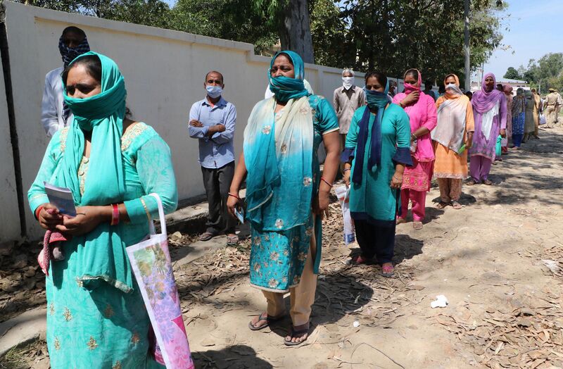 File:Pregnant women in Kashmir picking up health package.jpg