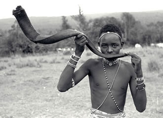 Samburu boy playing kudu horn.jpg