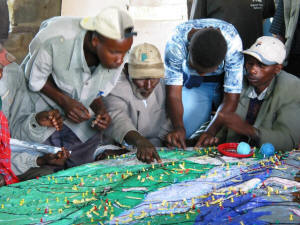 File:Ogiek Peoples locating their traditional spatial knowledge on a participatory 3D Model, Nessuit, Mau Forest Complex.jpg