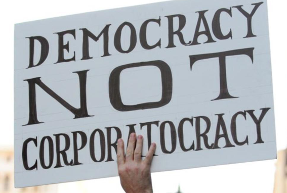 File:Democracy not corporation.png