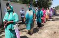 Pregnant women in Kashmir picking up health package.jpg