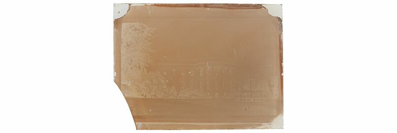 Example of a wet collodion negative with empty corners, a broken off corner and pour lines at the edges from the ​Graphic Atlas